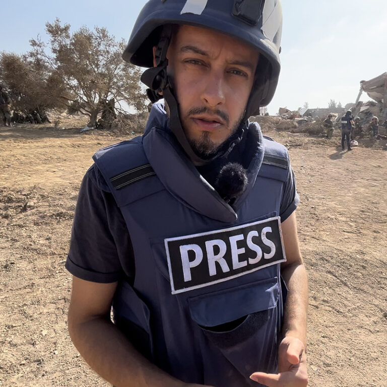 Secunder Kermani in a press bullet proof vest.