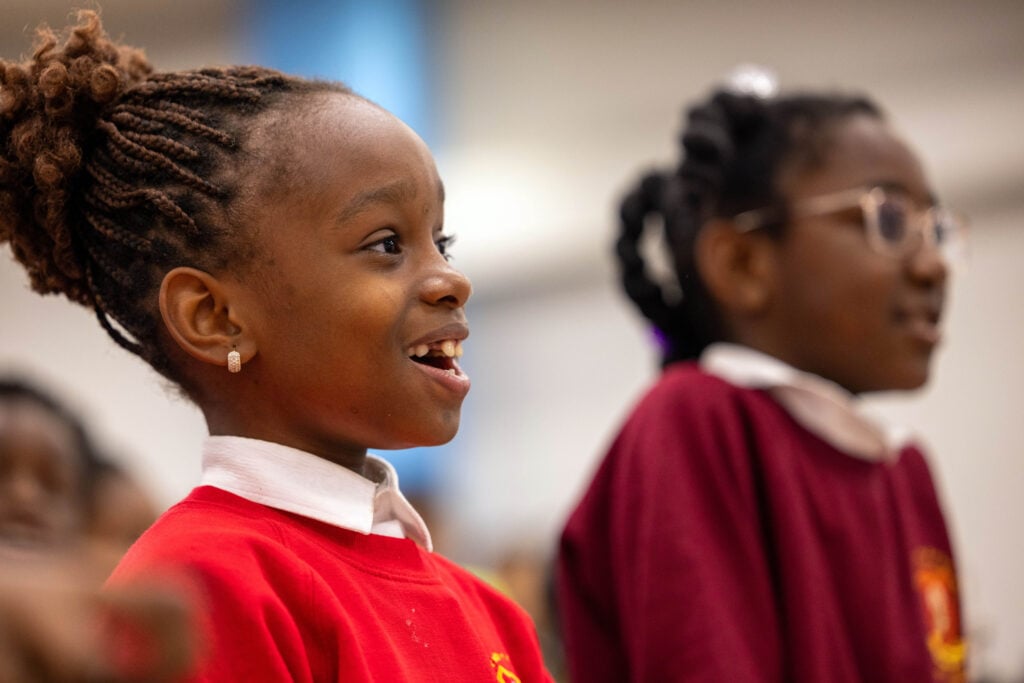 A primary school student smiles in delight at an Education day