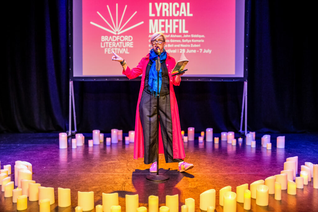 An artist performs at Lyrical Mehfil, in a circle of candles on stage